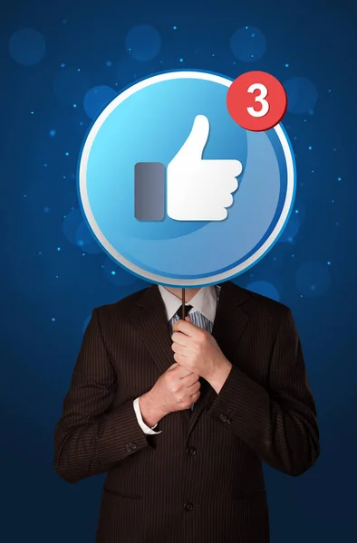 Businessman holding facebook sign — Stock Photo, Image