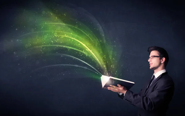 Young man holding book with wave — Stock Photo, Image