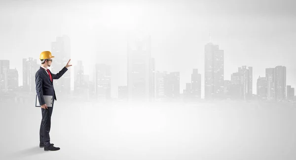 Architect standing and  looking at a big city panorama — Stock Photo, Image