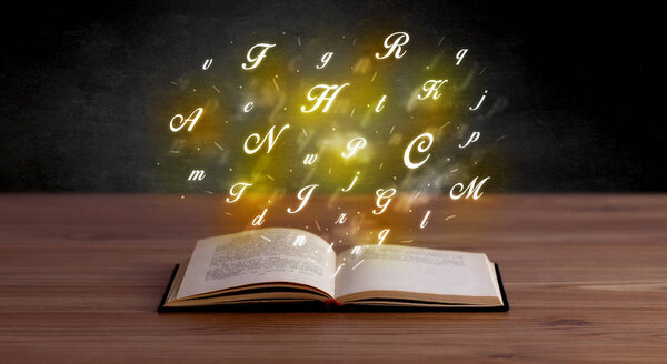 Glowing yellow alphabet letters coming out of an open book