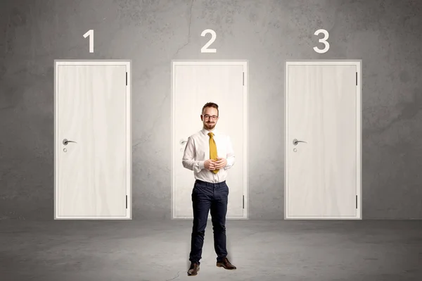 Businessman thinking in front of three doors — Stock Photo, Image