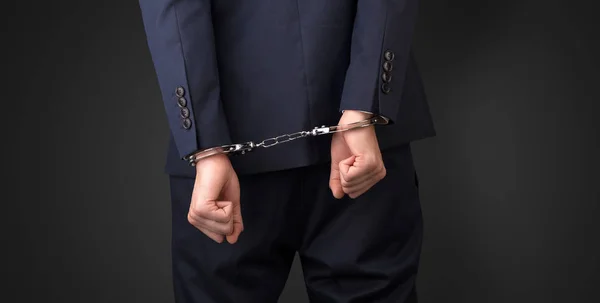 Dark backgrounded close handcuffed man — Stock Photo, Image