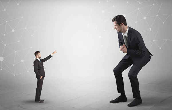 Small man aiming at a big man with network concept — Stock Photo, Image