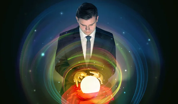 Man looking to the future of the word in a magic ball — Stock Photo, Image