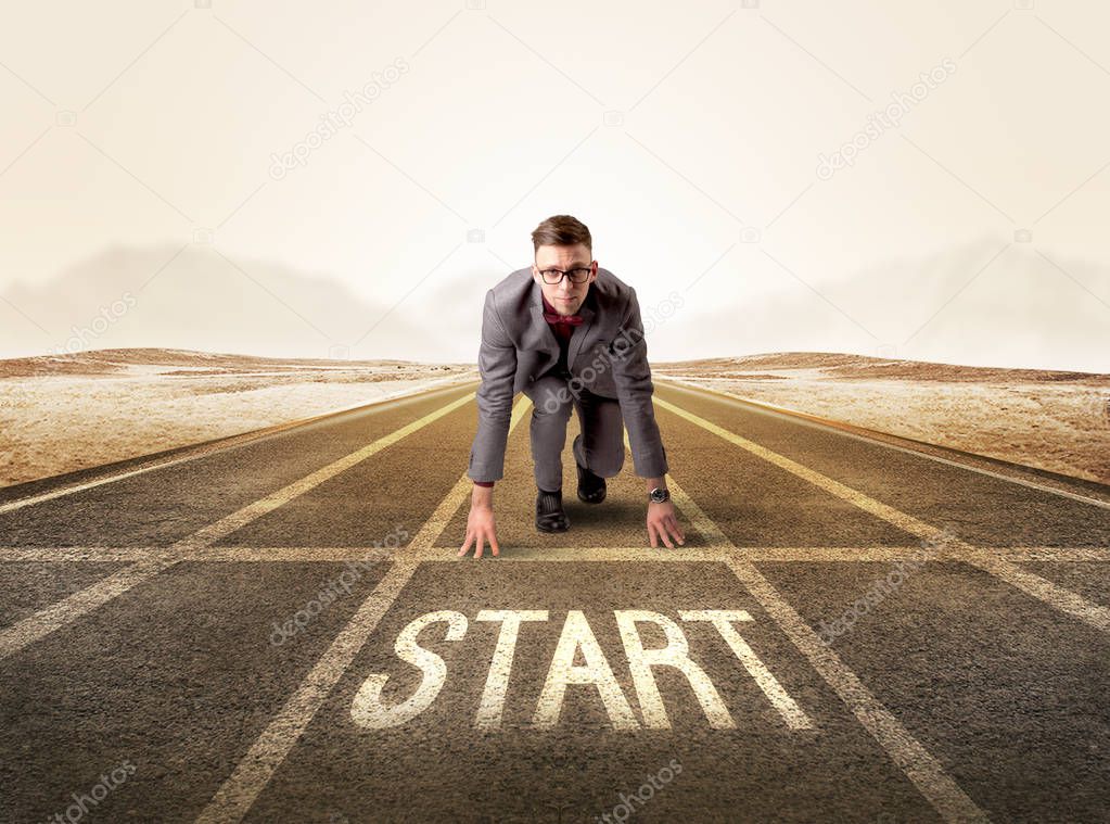 Businessman kneeling in ready position