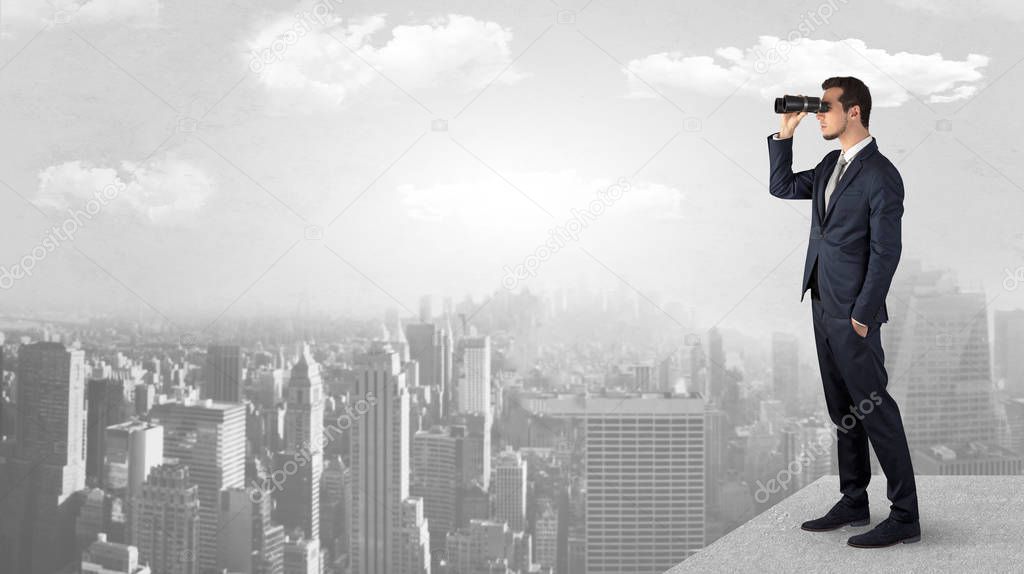 Man looking forward from the top of a skyscraper