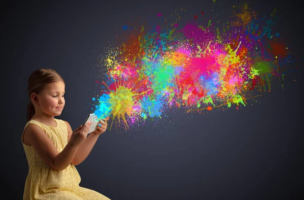 Girl holding tablet with colourful splash around — Stock Photo, Image