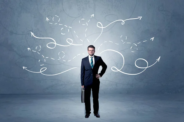 Businessman standing with winding arrows around — Stock Photo, Image