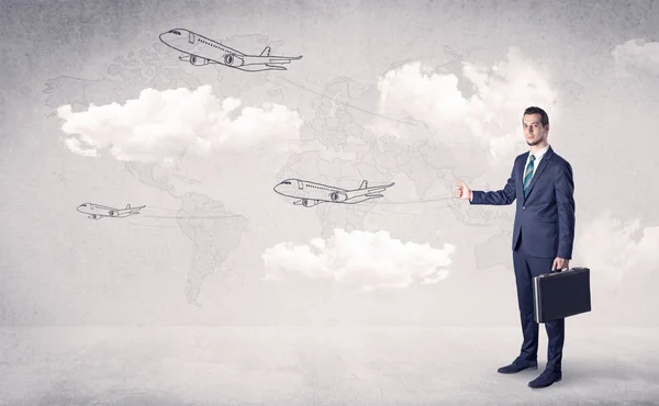 Businessman hitchhiking with airplanes around — Stock Photo, Image