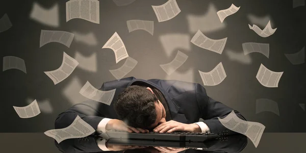 Businessman fell asleep at the office with paperwork concept