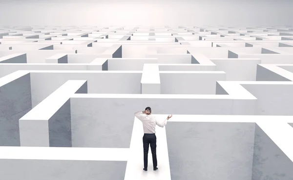 Small businessman in a middle of a maze — Stock Photo, Image