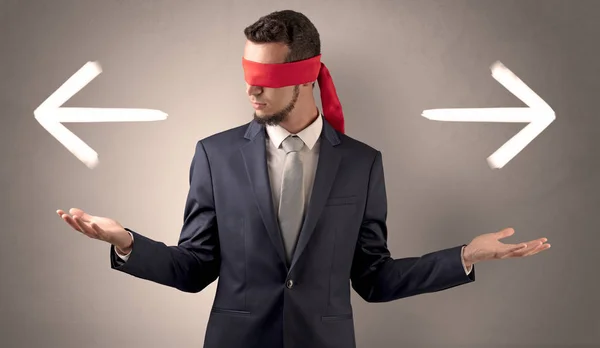 Covered eye businessman choosing direction — Stock Photo, Image