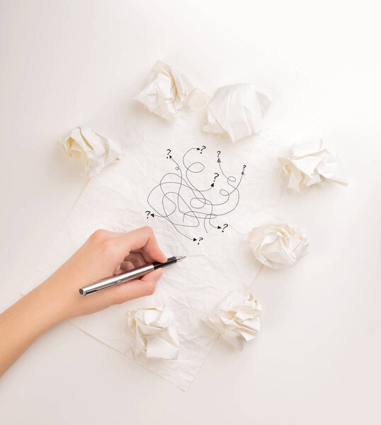 Writing hand in crumpled paper