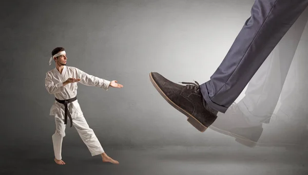 Kaki besar menginjak-injak orang karate kecil — Stok Foto