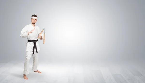 Karate trainer fighting in an empty space — Stock Photo, Image