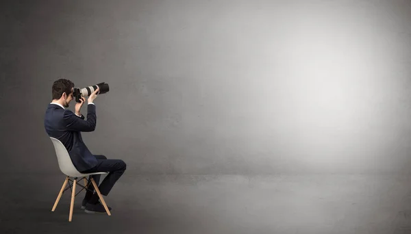 Businessman staying in an empty room with stuffs on his lap — Stock Photo, Image