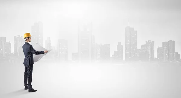 Architect standing and  looking at a big city panorama — Stock Photo, Image