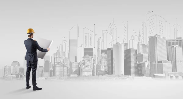 Architect standing and  replanning a city panorama — Stock Photo, Image