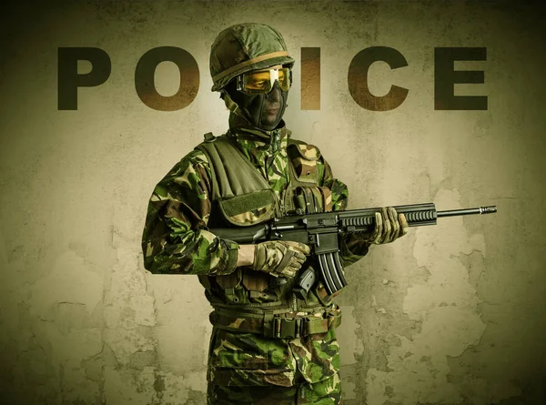 Armed soldier with damaged wall background — Stock Photo, Image
