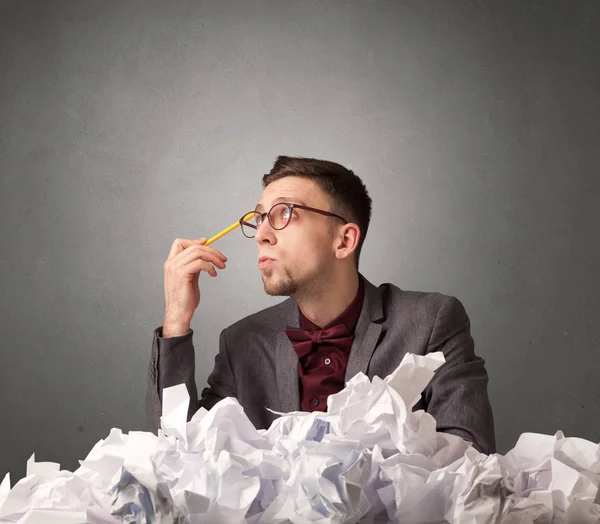 Businessman behind crumpled paper