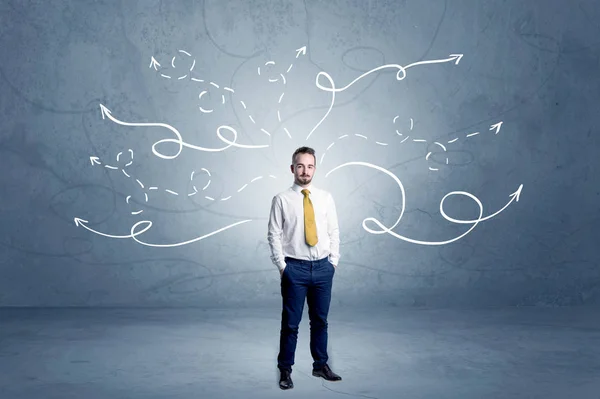 Businessman standing with winding arrows around — Stock Photo, Image