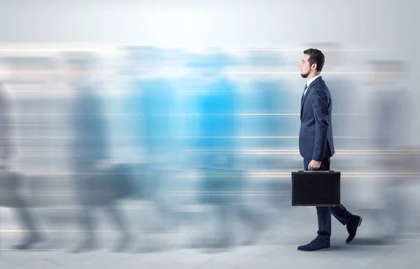 Businessman walking on a crowded street — Stock Photo, Image