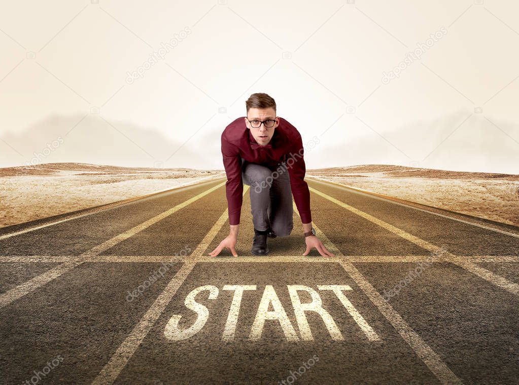 Businessman kneeling in ready position