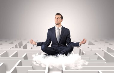 Businessman meditates on a cloud with maze concept clipart