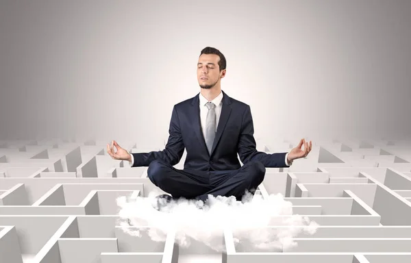 Businessman meditates on a cloud with maze concept — Stock Photo, Image