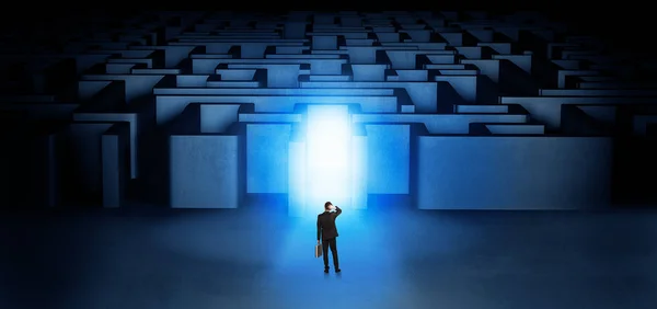 Lost businessman standing at illuminated labyrinth entrance — Stock Photo, Image