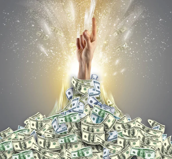 Hand bursting from a money heap — Stock Photo, Image