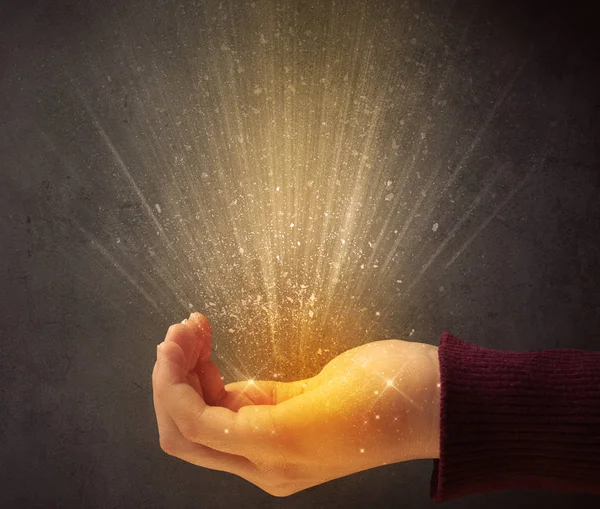 Hand holding yellow light — Stock Photo, Image