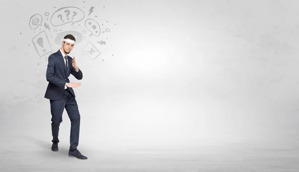 Businessman fighting with doodled symbols concept — Stock Photo, Image