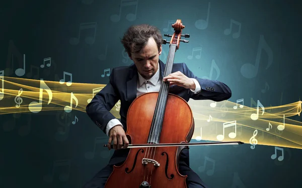 Musicien jouant sur violoncelle avec des notes autour — Photo