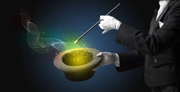 Illusionist hand making trick with wand — Stock Photo, Image