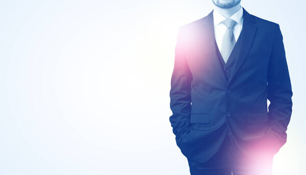 Young businessman standing and thinking
