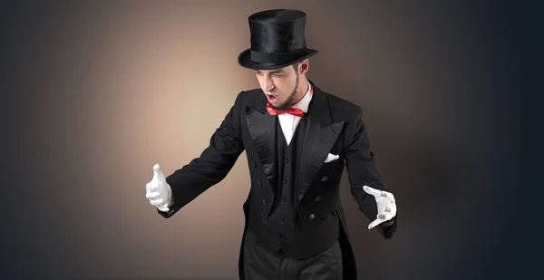 Magician holds something invisible Stock Picture