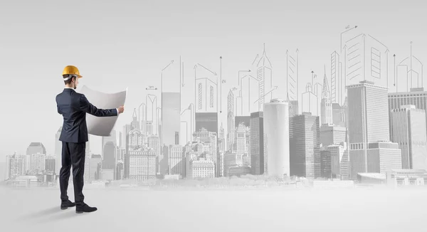 Arkitekten stående och omplanering ett city panorama — Stockfoto