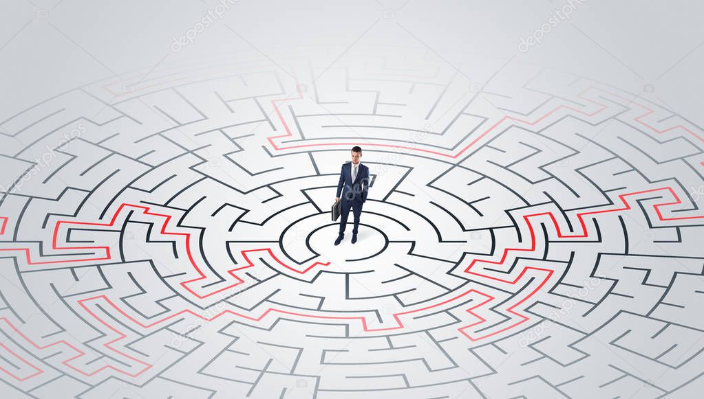 Young entrepreneur standing in a middle of a labyrinth 