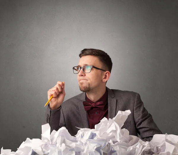 Businessman behind crumpled paper