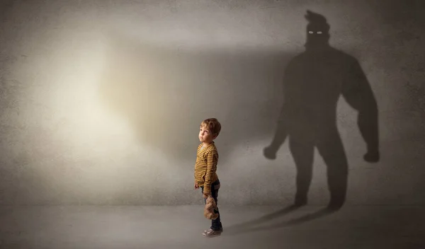 Cute kid with hero shadow behind — Stock Photo, Image