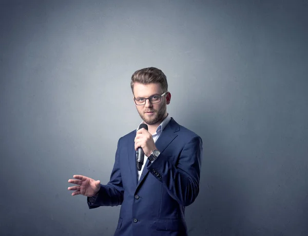 Businessman holding microphone — Stock Photo, Image