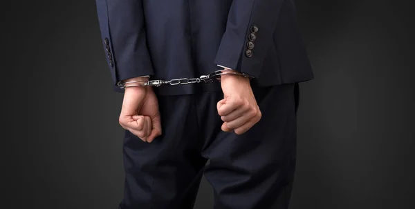 Dark backgrounded close handcuffed man — Stock Photo, Image