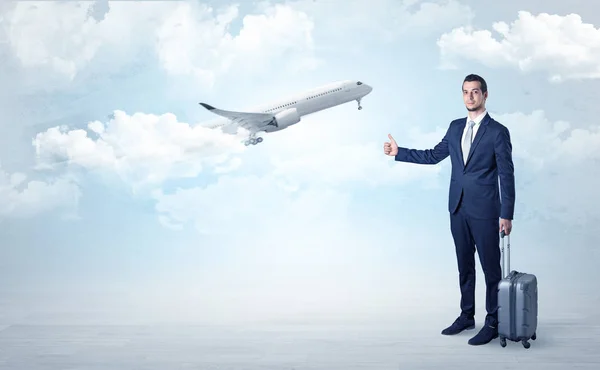 Agent hitchhiking with departing plane concept — Stock Photo, Image