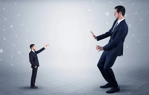 Small man aiming at a big man with network concept — Stock Photo, Image