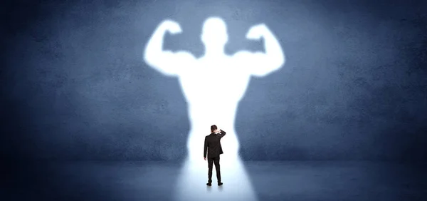 Businessman standing in front of a strong hero vision — Stock Photo, Image