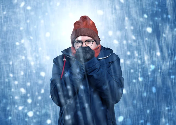 Handsome boy shivering at snowstorm concept Stock Picture