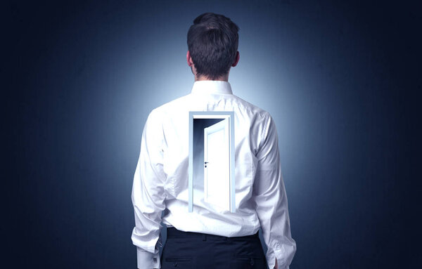 Businessman standing with door on his back