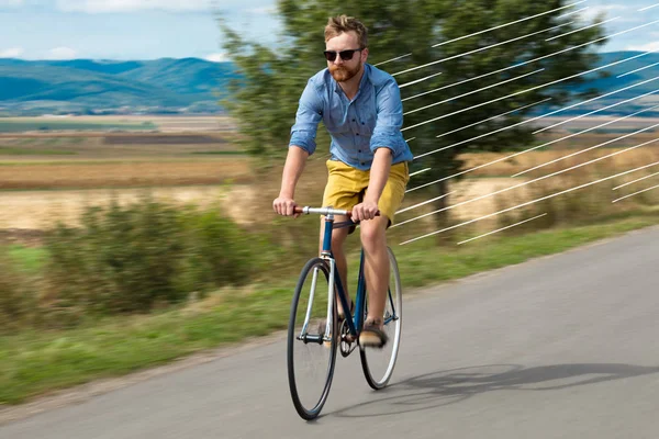 Casual cyclist riding bicycle very fast — Stock Photo, Image