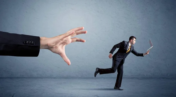 Businessman running from hand — Stock Photo, Image